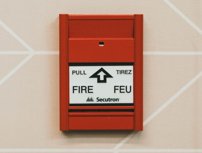 a red fire extinguisher mounted to the side of a wall